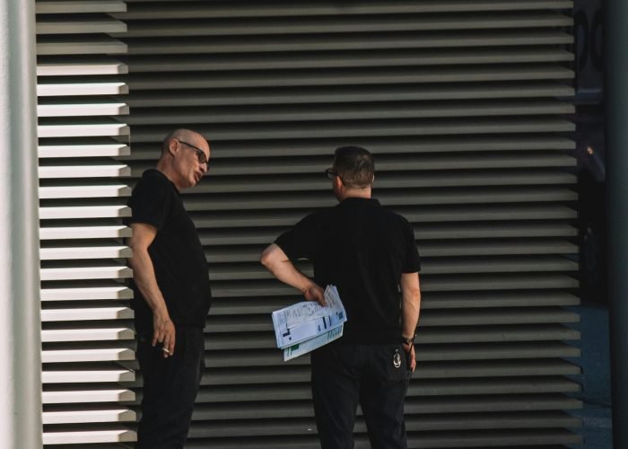 two security guards standing outside a building